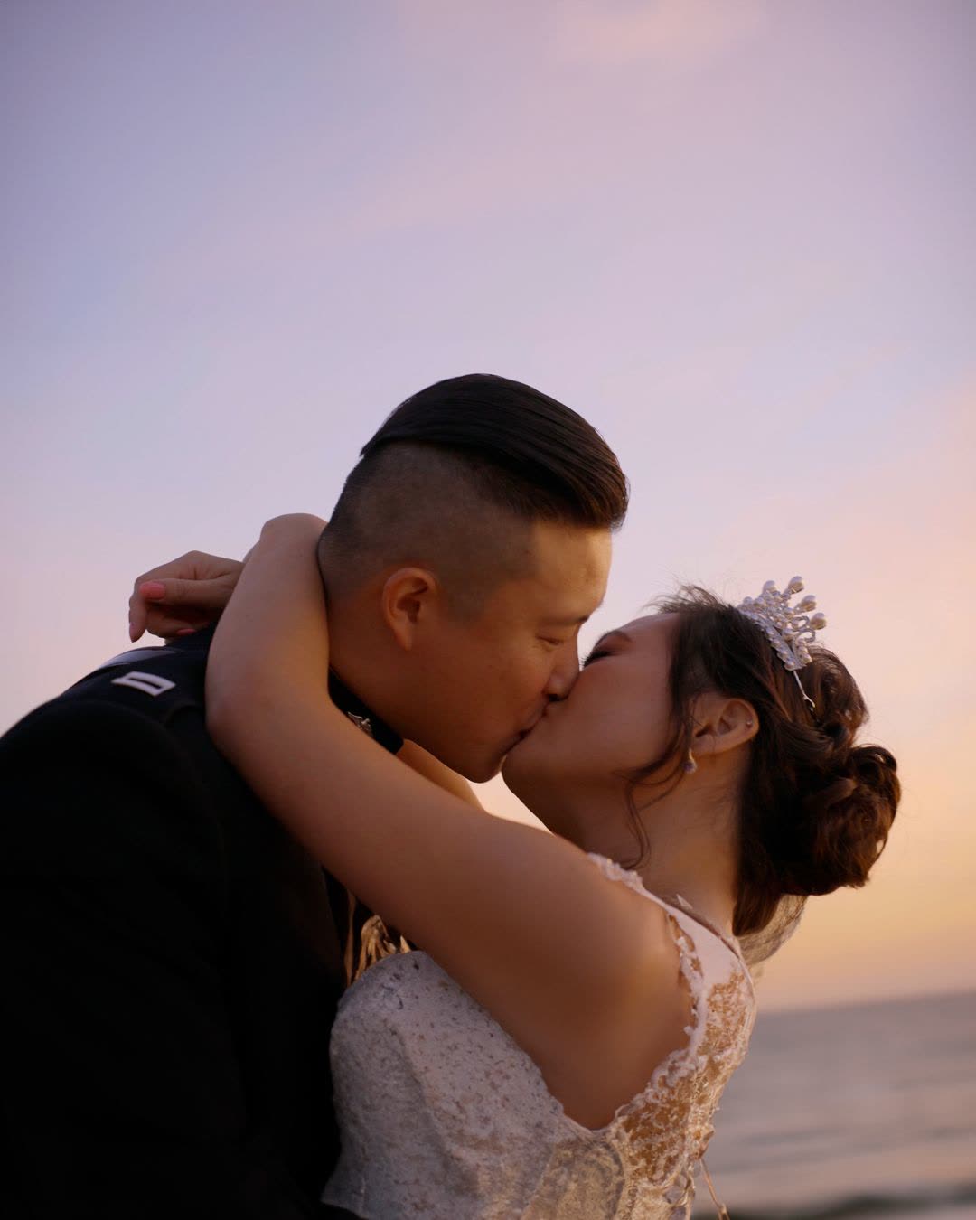 Couple kissing at sunset by the water